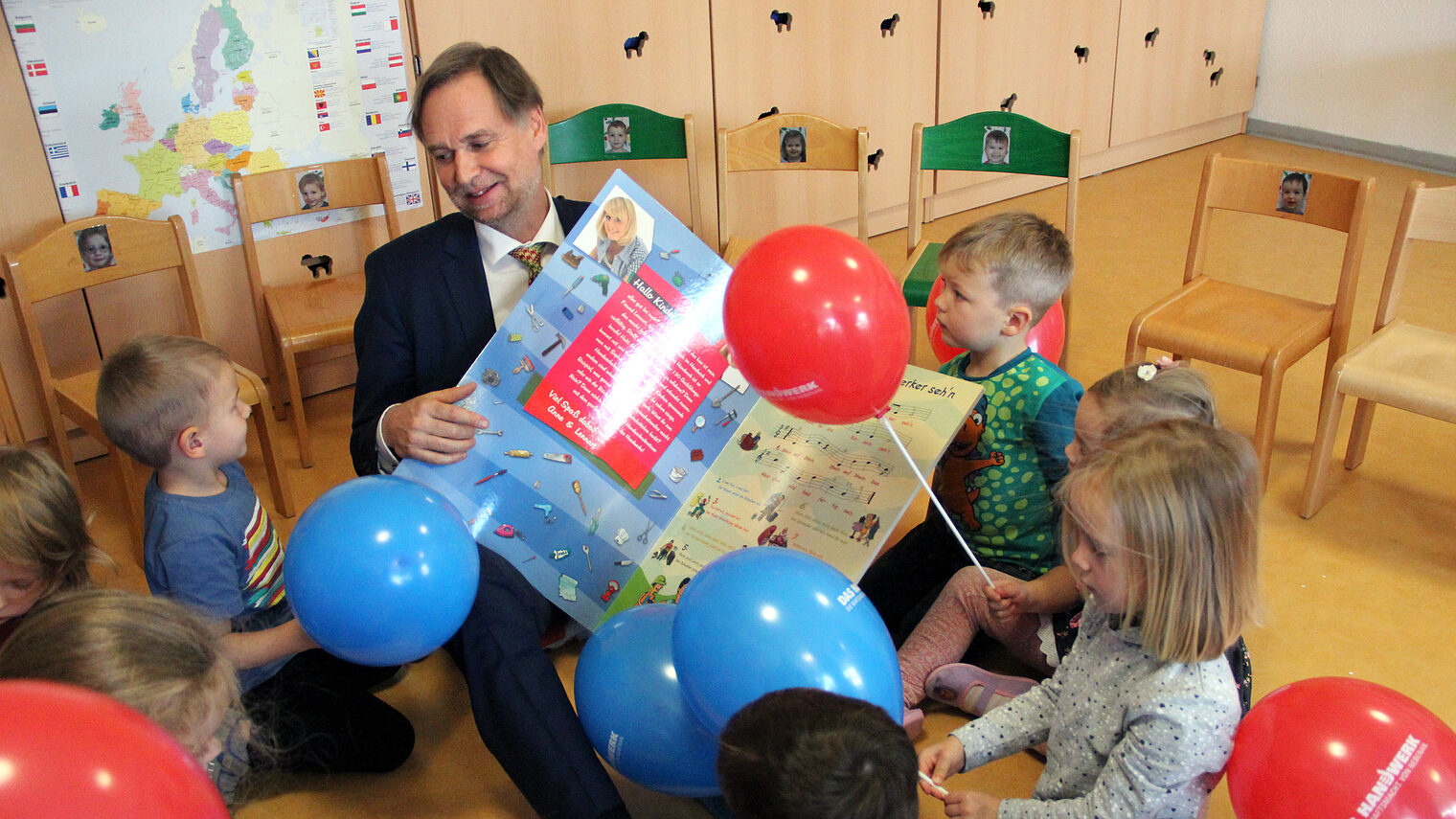 Handwerkskammer-Präsident Stefan Lobenstein singt mit den Kindern das Handwerker-Lied 