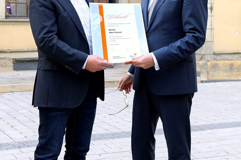 Für besondere Dienste um das Handwerk erhielt Uwe Crüger (li.) von Stefan Lobenstein die Ehrennadel des Thüringer Handwerkstages e.V.